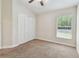 Bedroom features carpet, a window, and closet at 11506 Mansfield Point Dr, Riverview, FL 33569