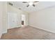 Neutral Primary bedroom with carpeting, a ceiling fan, and an ensuite bathroom at 11506 Mansfield Point Dr, Riverview, FL 33569