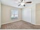 Bedroom featuring a closet, a window, a ceiling fan, and neutral carpeting at 11506 Mansfield Point Dr, Riverview, FL 33569