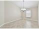 Dining room with tile flooring, a window with blinds, and a decorative chandelier at 11506 Mansfield Point Dr, Riverview, FL 33569