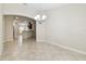 A dining room with tile flooring adjacent to kitchen with stainless steel appliances and a breakfast bar at 11506 Mansfield Point Dr, Riverview, FL 33569