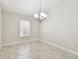 Cozy dining area with a chandelier, a window with blinds, and tile flooring at 11506 Mansfield Point Dr, Riverview, FL 33569
