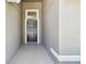 Stylish front door framed by elegant trim and modern gray tiling at 11506 Mansfield Point Dr, Riverview, FL 33569