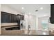 Modern kitchen with stainless steel appliances, dark cabinetry, and granite countertops at 11506 Mansfield Point Dr, Riverview, FL 33569