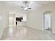 Bright living room with tile flooring, ceiling fan, and open floor plan to the kitchen at 11506 Mansfield Point Dr, Riverview, FL 33569