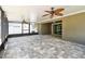 Enjoy the screened-in patio with ceiling fans, neutral flooring, and backyard view at 11506 Mansfield Point Dr, Riverview, FL 33569