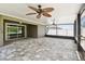 Expansive screened-in patio features stone floors, backyard views and ceiling fans at 11506 Mansfield Point Dr, Riverview, FL 33569