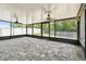 Spacious screened in porch with ceiling fans and exterior backyard view at 11506 Mansfield Point Dr, Riverview, FL 33569