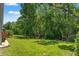 Expansive backyard features lush greenery and mature trees at 11800 Ivywood Pl, New Port Richey, FL 34654
