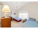 Cozy bedroom featuring two twin beds, a ceiling fan, and a dresser at 11800 Ivywood Pl, New Port Richey, FL 34654