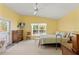 Comfortable bedroom with ample natural light, neutral carpet, and a ceiling fan for added comfort at 11800 Ivywood Pl, New Port Richey, FL 34654
