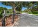 Gated community entrance with mature trees and meticulously maintained landscaping at 11800 Ivywood Pl, New Port Richey, FL 34654