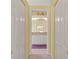 Hallway with walk in closet leading to a bathroom at 11800 Ivywood Pl, New Port Richey, FL 34654