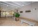 Community room breezeway with benches, iron gate, and brick pavers at 11800 Ivywood Pl, New Port Richey, FL 34654