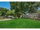 Community sign with mature trees and manicured landscaping in a green lawn area, evoking tranquility at 11800 Ivywood Pl, New Port Richey, FL 34654