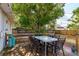 Backyard featuring a wooden deck with an outdoor dining set shaded by a large tree at 1253 Union St, Clearwater, FL 33755