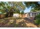 Expansive backyard with storage shed, wooden bench, grill, patio and access to the house at 1253 Union St, Clearwater, FL 33755