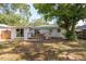 Open backyard featuring a patio with a grill and sliding glass doors leading to the home at 1253 Union St, Clearwater, FL 33755