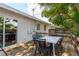 Backyard featuring a wooden deck with an outdoor dining set and large sliding glass door at 1253 Union St, Clearwater, FL 33755