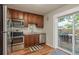 Well-equipped kitchen with stainless steel appliances and a view to a patio dining area at 1253 Union St, Clearwater, FL 33755