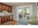Charming kitchen area featuring brown cabinetry with sliding glass doors to the backyard deck at 1253 Union St, Clearwater, FL 33755