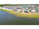 Aerial view of lakeside community with cozy backyards, with several houses featuring solar panels at 12775 Maple Bonsai Dr, Riverview, FL 33579