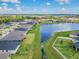 Backyard view of neighborhood homes along community pond at 12775 Maple Bonsai Dr, Riverview, FL 33579