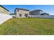 Spacious backyard featuring a lush green lawn and a white vinyl fence at 12775 Maple Bonsai Dr, Riverview, FL 33579