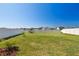 Expansive fenced backyard with lush green grass and seating area at 12775 Maple Bonsai Dr, Riverview, FL 33579