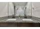 Modern bathroom featuring a double sink vanity, granite countertops, and neutral walls at 12775 Maple Bonsai Dr, Riverview, FL 33579