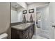 Bathroom features granite vanity top with integrated sink and view to the laundry room at 12775 Maple Bonsai Dr, Riverview, FL 33579