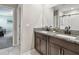 Elegant bathroom with granite countertops, double sinks, and a walk-in shower at 12775 Maple Bonsai Dr, Riverview, FL 33579