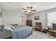 Relaxing bedroom with a ceiling fan, comfortable seating area, and natural light at 12775 Maple Bonsai Dr, Riverview, FL 33579