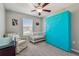 A cozy bedroom features neutral walls, and a pull down bed next to a crib at 12775 Maple Bonsai Dr, Riverview, FL 33579