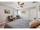 Bright bedroom with comfortable seating, a ceiling fan, and natural light at 12775 Maple Bonsai Dr, Riverview, FL 33579