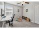 A cozy bedroom features neutral walls, ceiling fan, and a comfortable workspace at 12775 Maple Bonsai Dr, Riverview, FL 33579