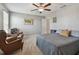 Inviting bedroom with a sitting area, comfortable bed, and ample natural light at 12775 Maple Bonsai Dr, Riverview, FL 33579