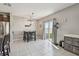 Open dining area with a modern light fixture and access to the backyard at 12775 Maple Bonsai Dr, Riverview, FL 33579