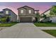 Two-story home with a two-car garage and a well-manicured front yard, complemented by a wide driveway at 12775 Maple Bonsai Dr, Riverview, FL 33579