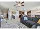 Inviting open-concept space featuring a large sofa, ceiling fan, and seamless flow to the kitchen at 12775 Maple Bonsai Dr, Riverview, FL 33579