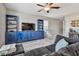Stylish living room features a blue entertainment center and a modern ceiling fan, creating a cozy atmosphere at 12775 Maple Bonsai Dr, Riverview, FL 33579