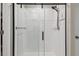 Modern bathroom with a sleek glass-enclosed shower and white tile at 12775 Maple Bonsai Dr, Riverview, FL 33579