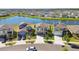 Street view shows new homes with wide driveways and well-manicured lawns near the lake at 12775 Maple Bonsai Dr, Riverview, FL 33579