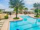 Community swimming pool surrounded by palm trees, lounge chairs, and comfortable cabanas, perfect for relaxation and recreation at 12775 Maple Bonsai Dr, Riverview, FL 33579