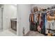 This walk-in closet has ample clothing rack space and storage for folded items at 12775 Maple Bonsai Dr, Riverview, FL 33579