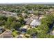 An aerial view showcases the neighborhood with neat streets and tree-lined properties at 1285 Salt Lake Dr, Tarpon Springs, FL 34689