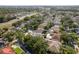 An aerial view of a residential neighborhood with mature trees and well-maintained homes at 1285 Salt Lake Dr, Tarpon Springs, FL 34689