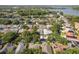 Aerial view of a residential community with lush trees and a lake in the background at 1285 Salt Lake Dr, Tarpon Springs, FL 34689