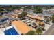 Aerial view highlighting an area with orange-roofed buildings and outdoor seating areas, creating a charming business district at 1285 Salt Lake Dr, Tarpon Springs, FL 34689
