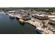 Waterfront community featuring docks with boats, local businesses, and parking along the waterway under a sunny sky at 1285 Salt Lake Dr, Tarpon Springs, FL 34689